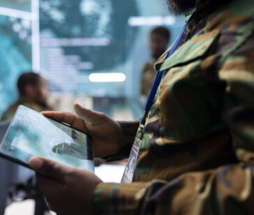 High tech military office with soldiers analyzing real time data, processing intelligence information and coordinating strategic operations to support military missions effectively.